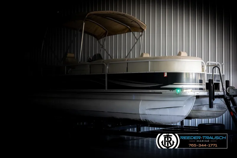 Slide: The Image of 2011 Misty Harbor 2285 CS pontoon boat in a dimly lit storage area. - 4