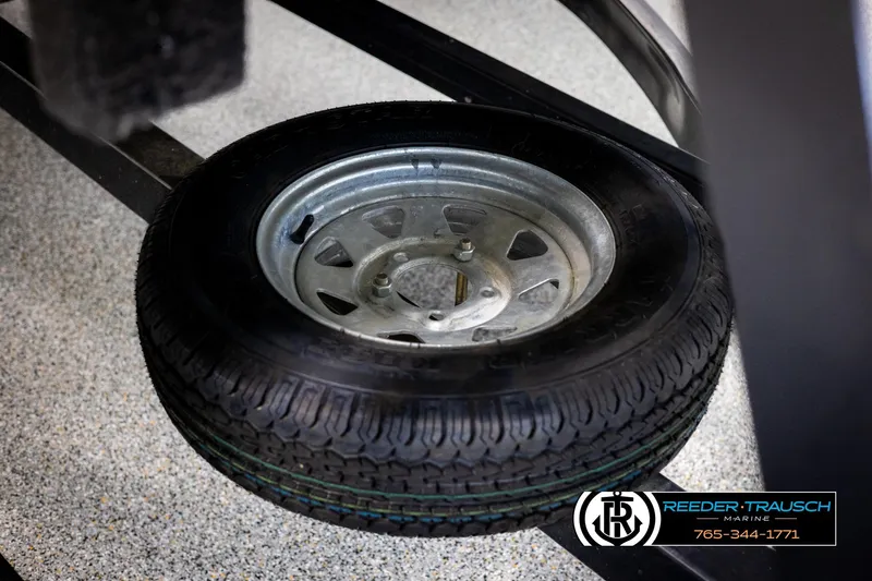 Slide: The Image of Spare tire for 2011 Misty Harbor 2285 CS boat trailer, displayed on showroom floor. - 45