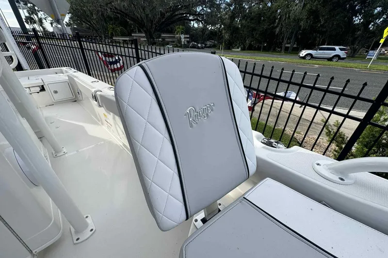 Slide: The Image of 2026 Ranger 2510 Bay boat interior with white cushioned seating and sleek design. - 10