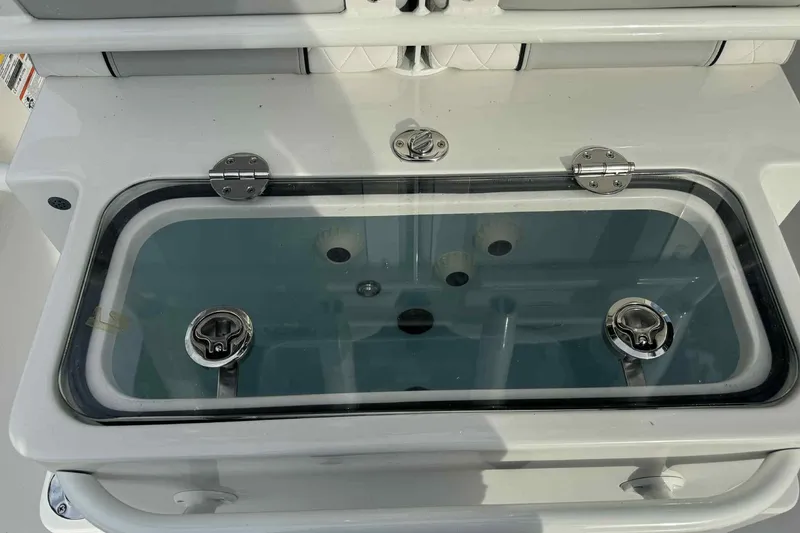 Slide: The Image of Livewell on 2026 Ranger 2510 Bay boat, featuring secure latches and clear lid. - 11