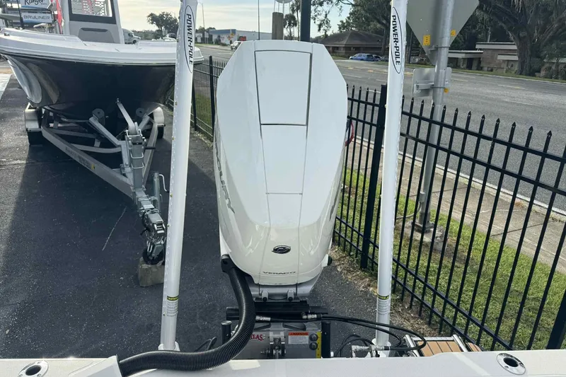Slide: The Image of 2026 Ranger 2510 Bay boat with Mercury engine and Power-Pole anchors, parked on a trailer. - 12