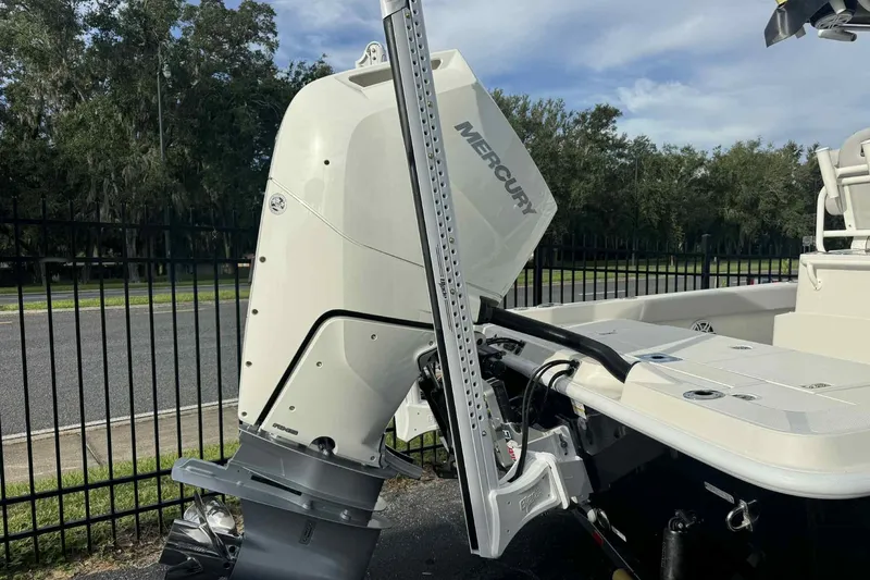 Slide: The Image of 2026 Ranger 2510 Bay boat with Mercury outboard engine, parked near a fence. - 15