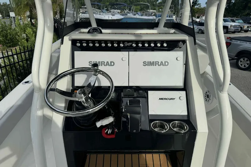 Slide: The Image of 2026 Ranger 2510 Bay boat dashboard with Simrad and Mercury controls. - 2