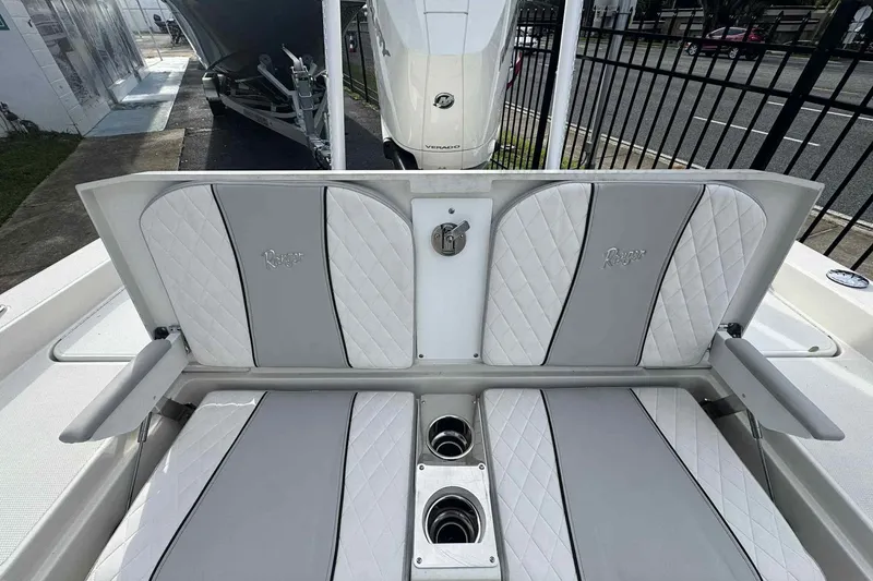 Slide: The Image of 2026 Ranger 2510 Bay boat interior with cushioned seating and cup holders. - 4