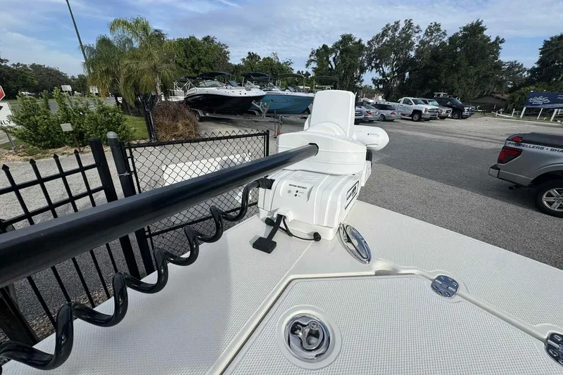 Slide: The Image of 2026 Ranger 2510 Bay boat with trolling motor in a parking lot setting. - 6