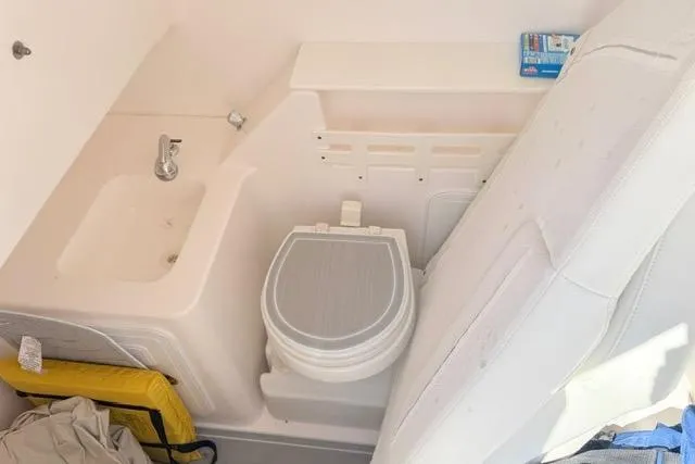 Slide: The Image of Interior of 2014 Everglades 325 Center Console boat with window and storage compartments. - 18