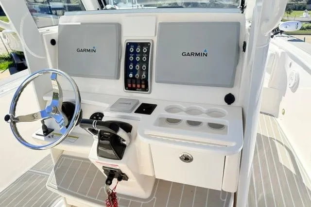 Slide: The Image of 2014 Everglades 325 Center Console boat deck with seating and storage compartments. - 22