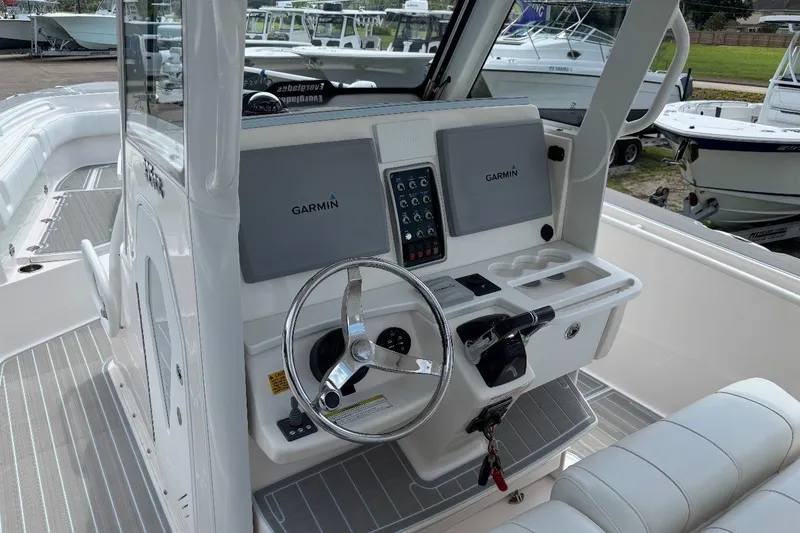 Slide: The Image of 2014 Everglades 325 Center Console boat with dual Yamaha engines on a trailer. - 4