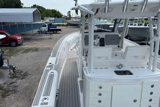 Slide: The Image of 2014 Everglades 325 Center Console boat deck with rod holders and measuring board. - 5