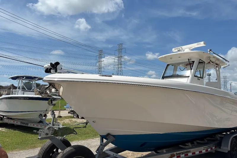 Slide: The Image of 2014 Everglades 325 Center Console boat deck with storage compartments and clean design. - 6