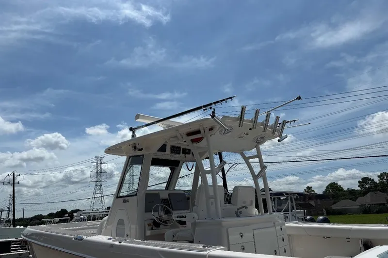 Slide: The Image of 2014 Everglades 325 Center Console boat with sleek design and spacious deck. - 7
