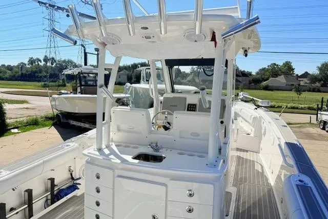 Slide: The Image of 2014 Everglades 325 Center Console boat interior with steering wheel and seating. - 8
