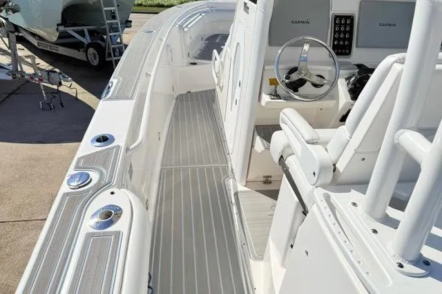 Slide: The Image of 2014 Everglades 325 Center Console boat with sink and storage compartments. - 9