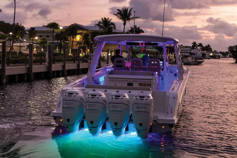 Slide: The Image of Manufacturer Provided Image: 2020 Boston Whaler 420 Outrage boat with illuminated engines at sunset. - 4