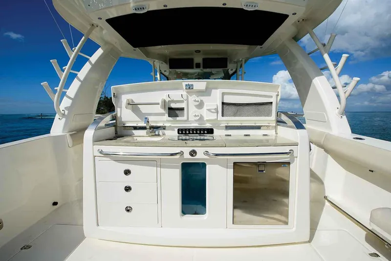 Slide: The Image of Manufacturer Provided Image: 2020 Boston Whaler 420 Outrage boat interior with fishing station and storage compartments. - 9