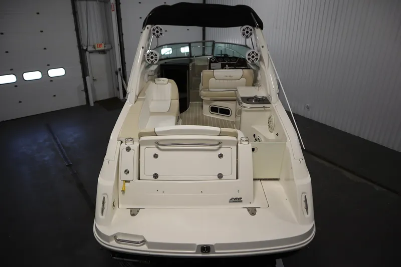 Slide: The Image of 2013 Sea Ray 280 Sundancer boat interior with seating and control panel. - 10
