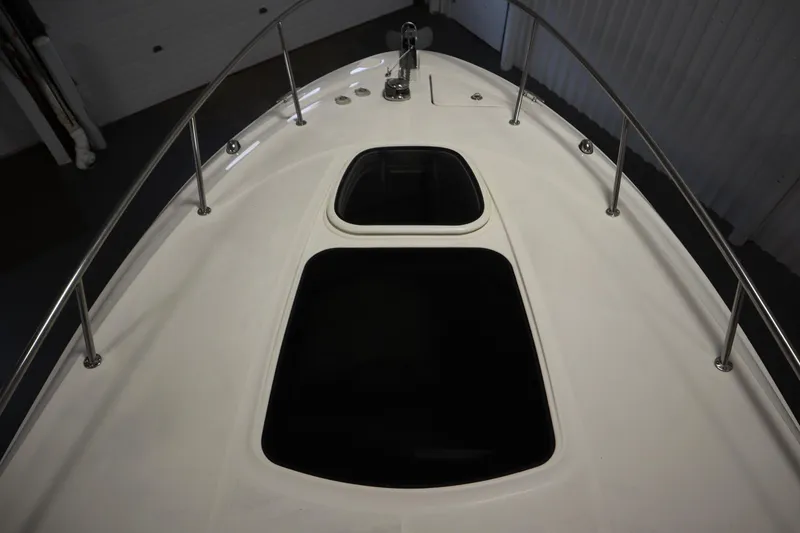 Slide: The Image of 2013 Sea Ray 280 Sundancer boat deck with hatches and railings. - 11