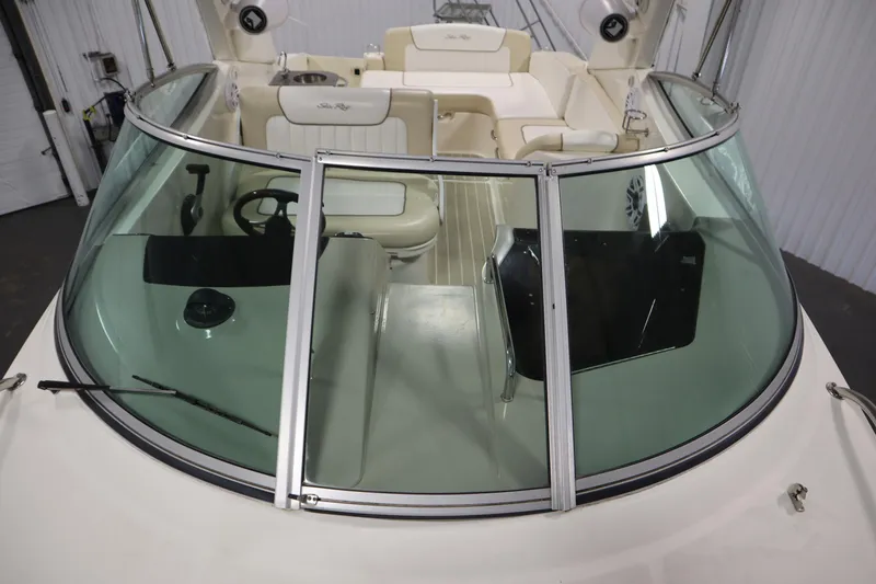 Slide: The Image of 2013 Sea Ray 280 Sundancer boat interior with windshield and seating area. - 16