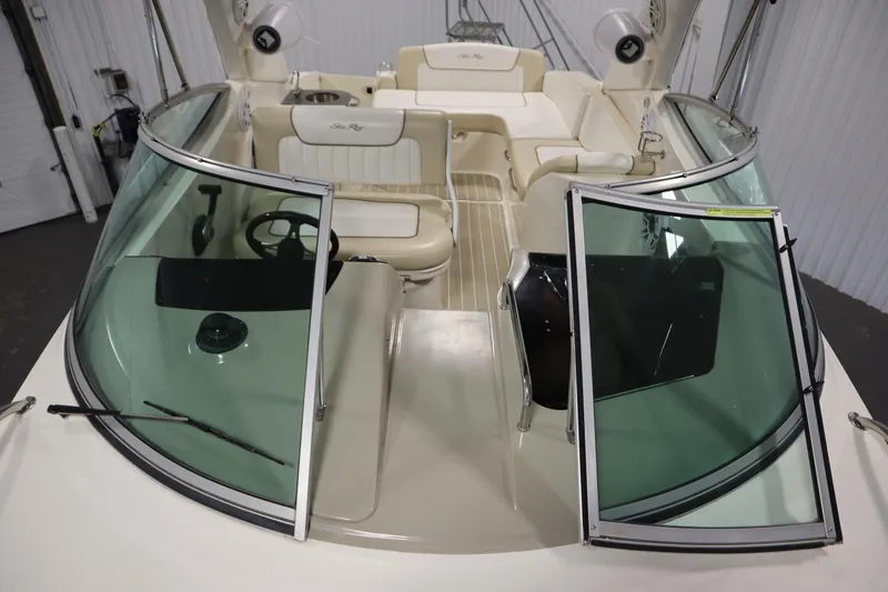 Slide: The Image of 2013 Sea Ray 280 Sundancer boat interior with open windshield and seating area. - 17