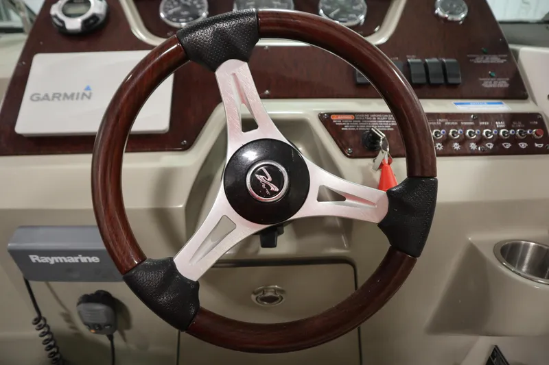 Slide: The Image of Steering wheel of a 2013 Sea Ray 280 Sundancer boat with Garmin and Raymarine equipment. - 20