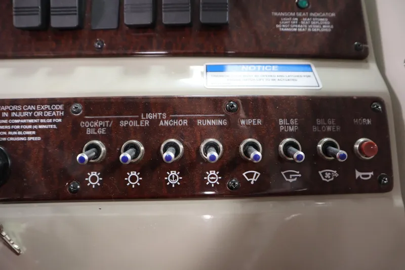 Slide: The Image of Control panel of a 2013 Sea Ray 280 Sundancer boat with various switches. - 29
