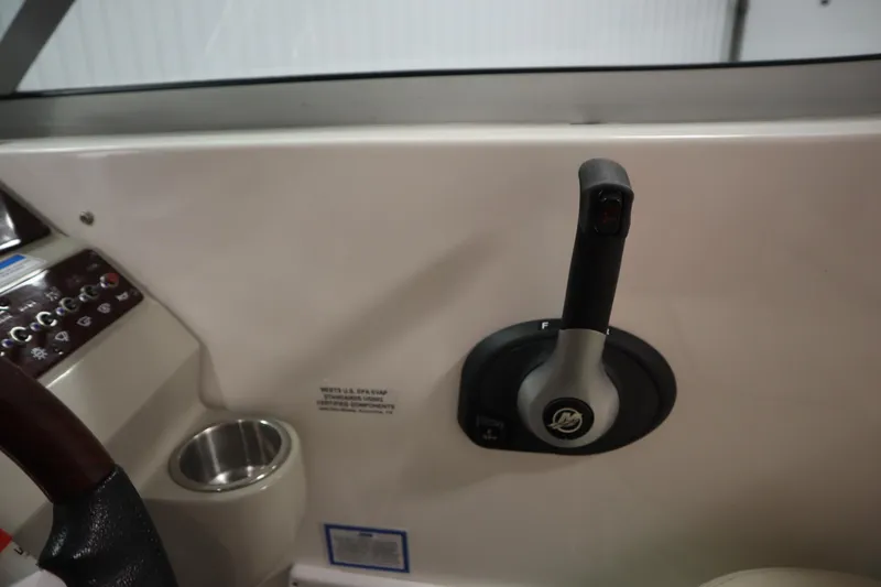 Slide: The Image of Control panel of a 2013 Sea Ray 280 Sundancer boat with throttle lever. - 33