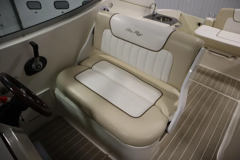 Slide: The Image of 2013 Sea Ray 280 Sundancer interior with beige seating and steering wheel. - 36