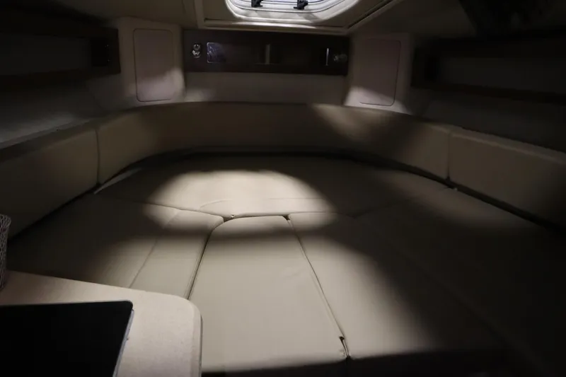 Slide: The Image of Interior cabin of 2013 Sea Ray 280 Sundancer with beige seating and overhead hatch. - 41