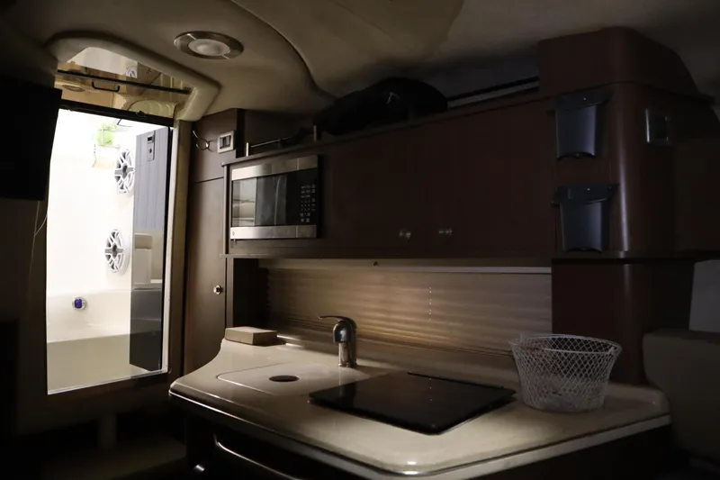 Slide: The Image of Interior of 2013 Sea Ray 280 Sundancer boat with kitchenette and microwave. - 48