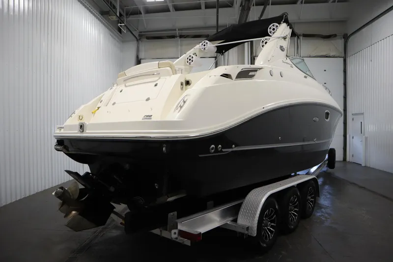 Slide: The Image of 2013 Sea Ray 280 Sundancer boat on trailer in indoor storage facility. - 5