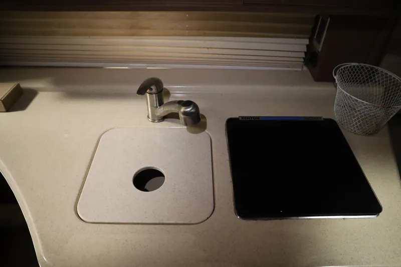 Slide: The Image of 2013 Sea Ray 280 Sundancer kitchen sink with faucet and countertop accessories. - 50