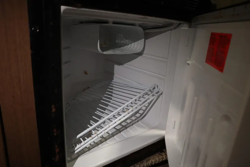 Slide: The Image of Empty refrigerator inside 2013 Sea Ray 280 Sundancer boat, open door view. - 53