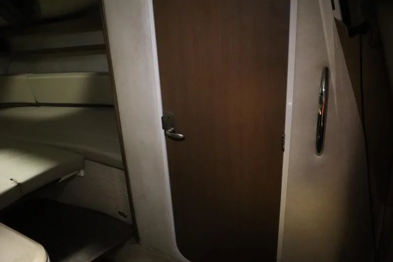 Slide: The Image of Interior cabin view of 2013 Sea Ray 280 Sundancer with closed wooden door. - 55