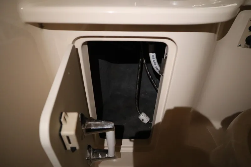 Slide: The Image of Open compartment on 2013 Sea Ray 280 Sundancer boat, showing interior wiring. - 57