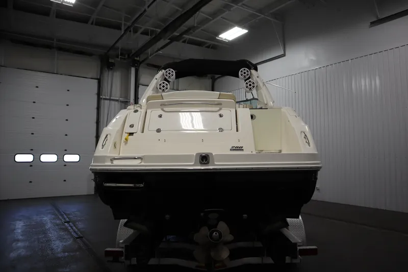 Slide: The Image of 2013 Sea Ray 280 Sundancer boat in indoor storage, rear view. - 6