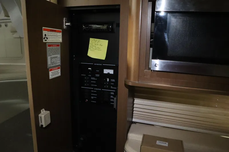 Slide: The Image of 2013 Sea Ray 280 Sundancer interior with control panel and microwave. - 60