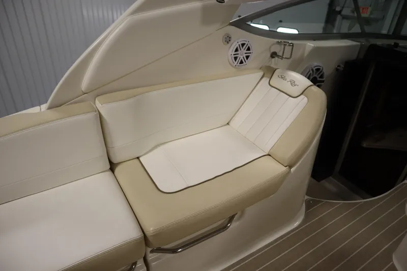 Slide: The Image of 2013 Sea Ray 280 Sundancer interior seating with beige and white upholstery. - 68