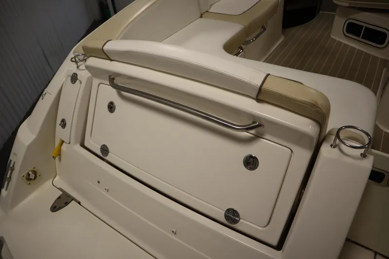 Slide: The Image of 2013 Sea Ray 280 Sundancer boat interior with seating and storage compartment. - 76