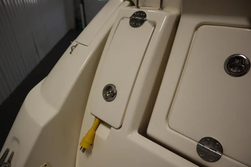 Slide: The Image of 2013 Sea Ray 280 Sundancer boat with electrical outlet and storage compartments. - 78