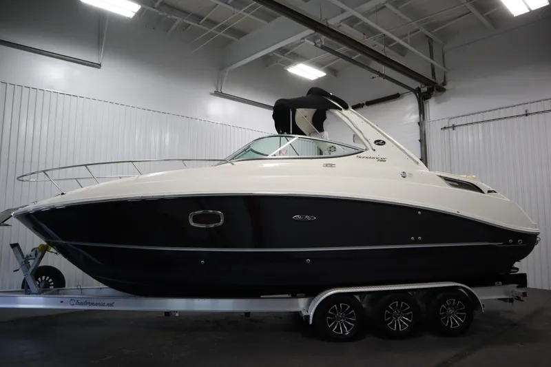 Slide: The Image of 2013 Sea Ray 280 Sundancer boat on trailer in indoor storage facility. - 8