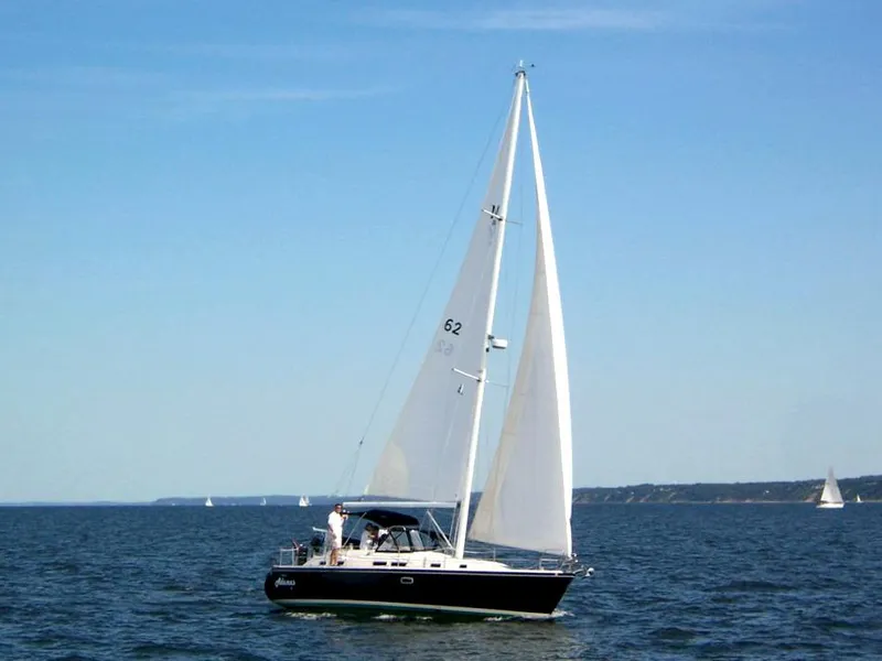 Slide: The Image of Sailboat Catalina Morgan 38, 1997 model, cruising on open water under clear blue sky. - 1