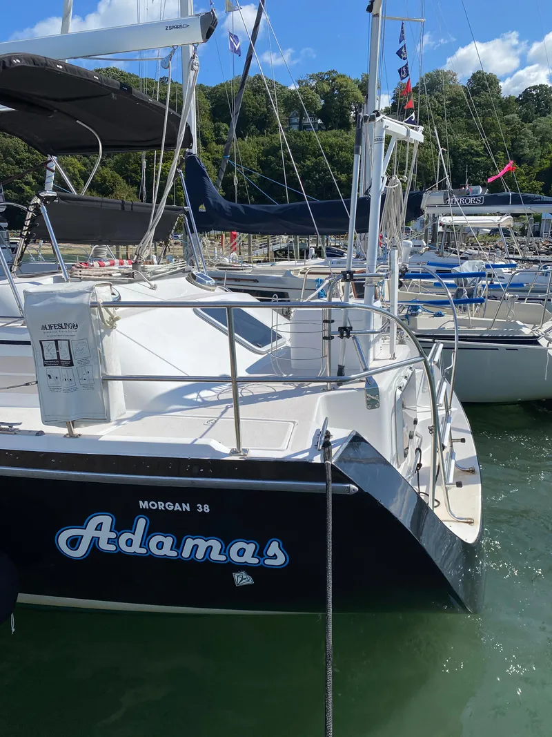 Slide: The Image of Sailboat "Adamas" docked, Catalina Morgan 38, 1997 model, in a sunny marina setting. - 10