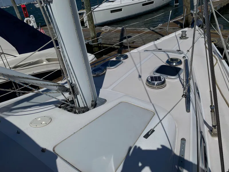 Slide: The Image of Deck view of a 1997 Catalina Morgan 38 sailboat docked at a marina. - 16
