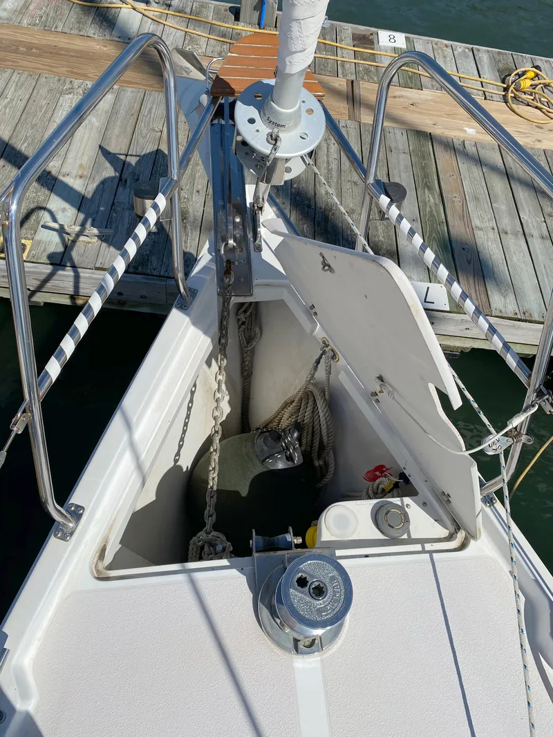 Slide: The Image of 1997 Catalina Morgan 38 sailboat bow with anchor and dock view. - 17