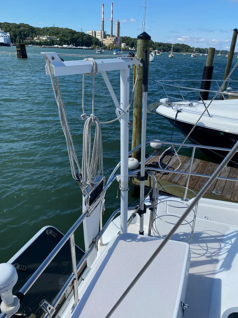 Slide: The Image of 1997 Catalina Morgan 38 sailboat docked by the water with clear skies. - 18