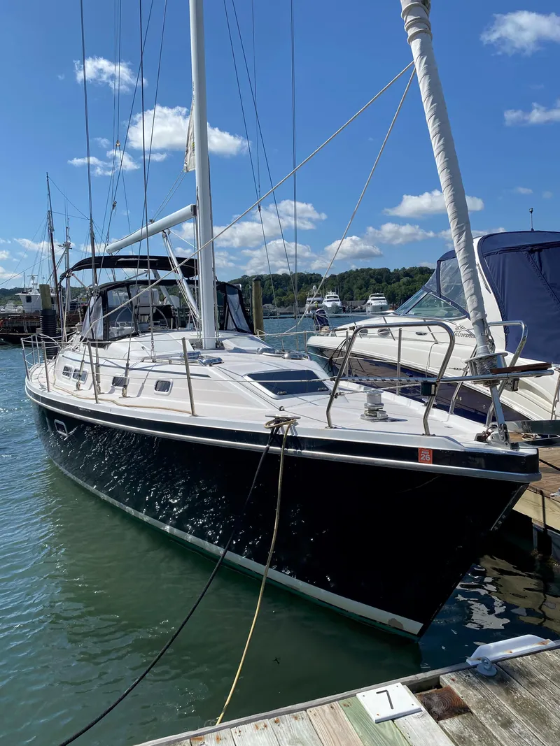 Slide: The Image of 1997 Catalina Morgan 38 sailboat docked in a marina under a clear blue sky. - 2
