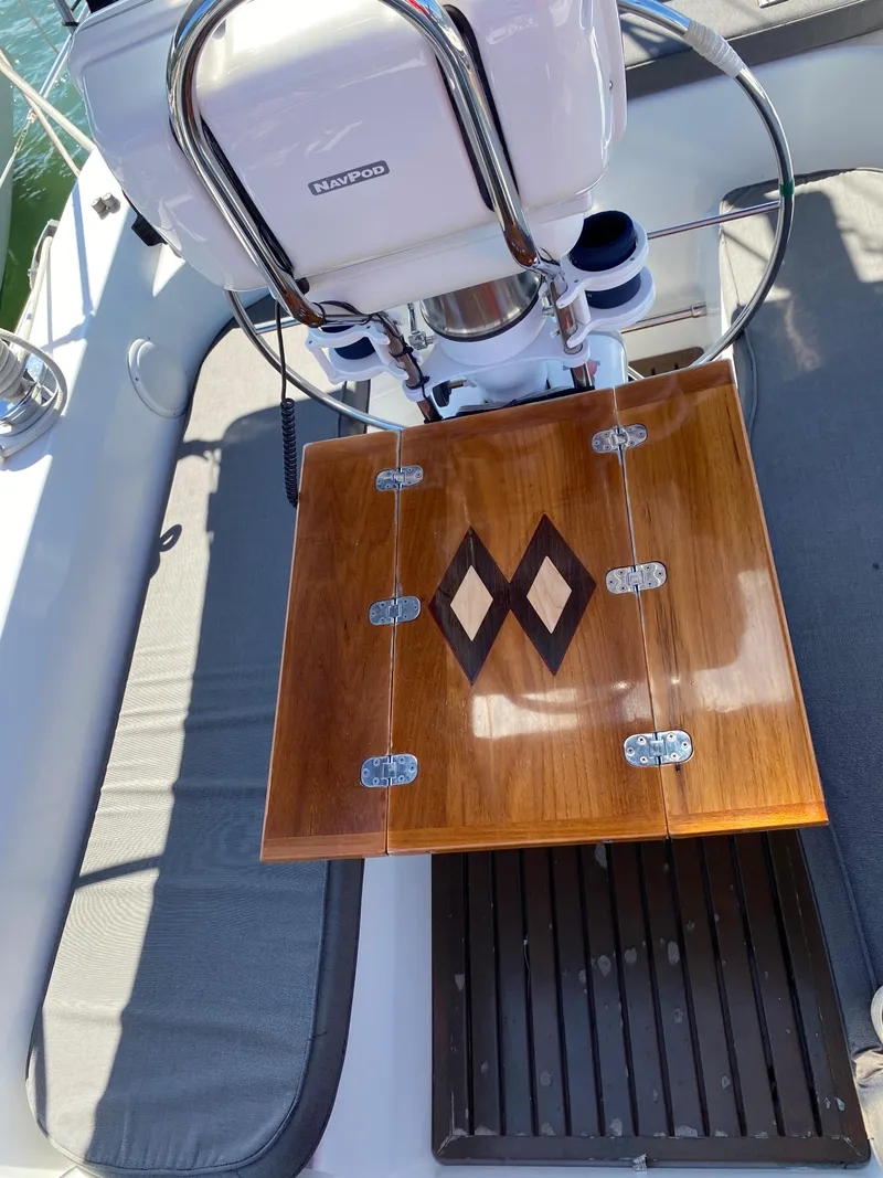 Slide: The Image of Cockpit of 1997 Catalina Morgan 38 sailboat with wooden folding table and steering wheel. - 23