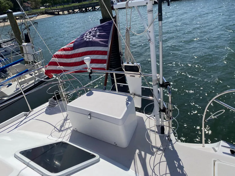 Slide: The Image of Sailboat deck of 1997 Catalina Morgan 38 with American flag, docked by the water. - 24