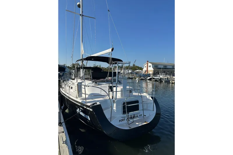Slide: The Image of Catalina Morgan 38 sailboat, 1997 model, docked at marina under clear blue sky. - 27