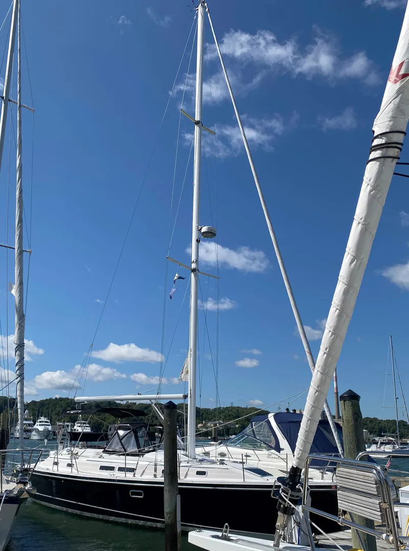 Slide: The Image of 1997 Catalina Morgan 38 sailboat docked under clear blue sky. - 3